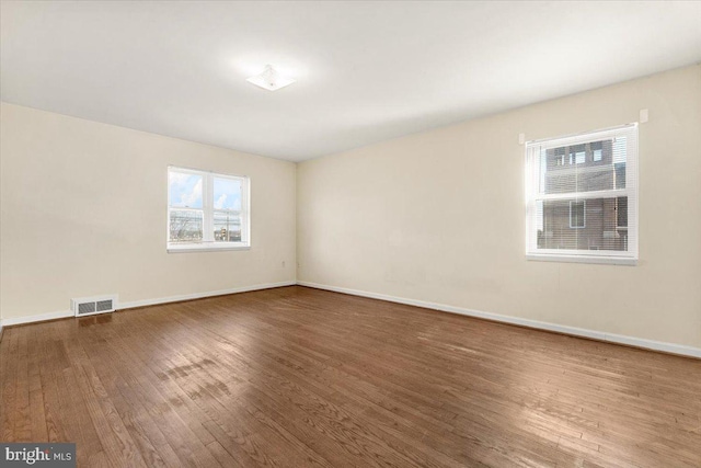 spare room with dark wood-type flooring