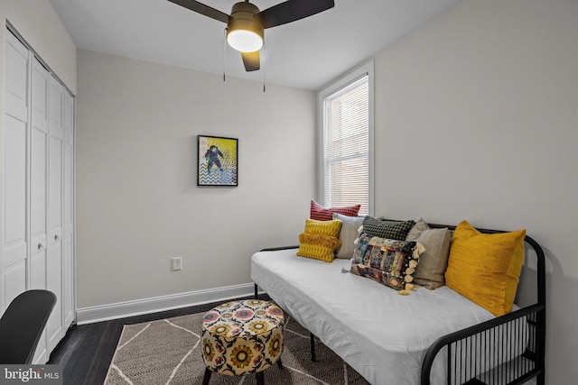 sitting room featuring dark hardwood / wood-style floors and ceiling fan