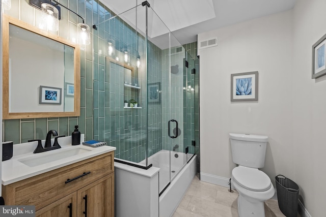 full bathroom with tile patterned flooring, bath / shower combo with glass door, vanity, tasteful backsplash, and toilet