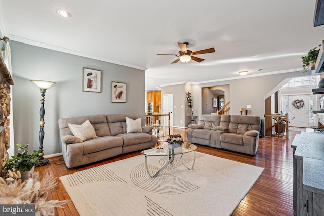 living room featuring crown molding, dark hardwood / wood-style floors, and ceiling fan