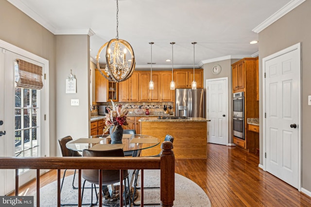 dining area with french doors, ornamental molding, dark hardwood / wood-style floors, and a notable chandelier