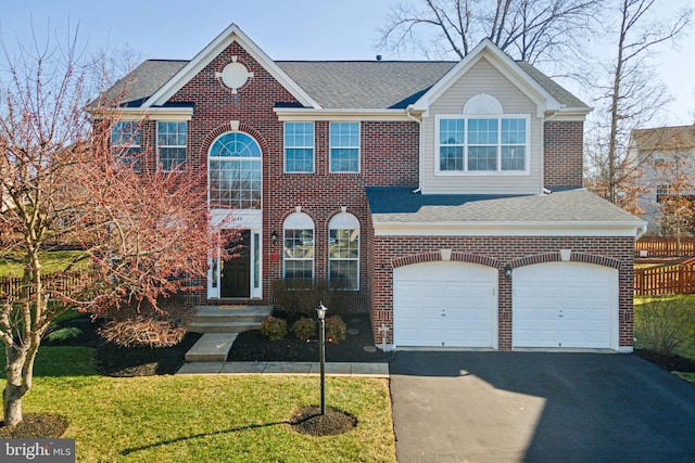 view of front of home with a garage and a front yard