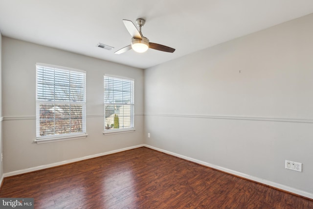 spare room with ceiling fan and dark hardwood / wood-style floors