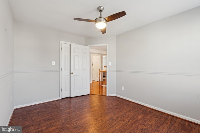 unfurnished bedroom with ceiling fan, dark hardwood / wood-style flooring, and a closet