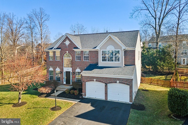 view of front facade with a garage and a front yard