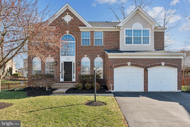 view of front of property featuring a garage and a front lawn