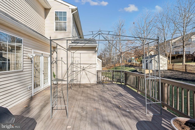 wooden deck featuring a storage unit