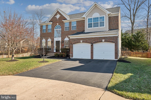 view of front of house with a garage and a front yard