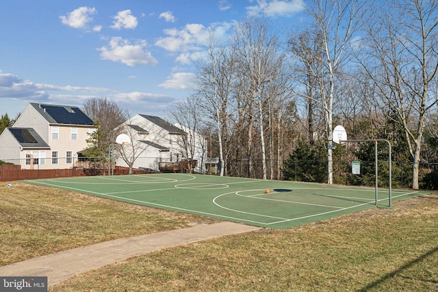 view of basketball court with a yard