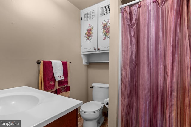 bathroom featuring vanity and toilet