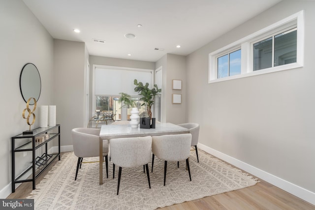 dining space with light hardwood / wood-style floors