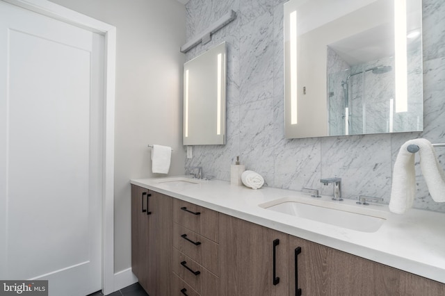 bathroom with vanity and a shower with shower door