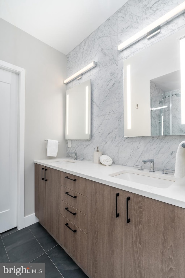 bathroom featuring decorative backsplash, tile patterned floors, vanity, and a shower