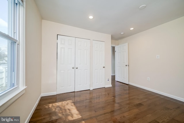 unfurnished bedroom with dark hardwood / wood-style floors