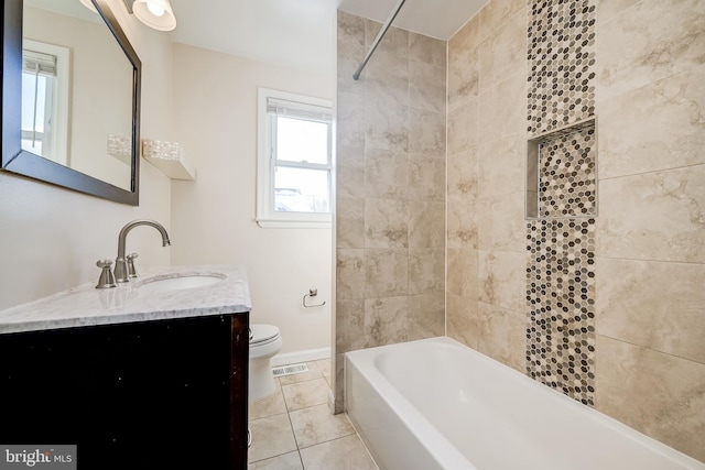 full bathroom featuring tiled shower / bath, tile patterned floors, toilet, and vanity