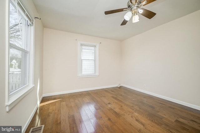 spare room with hardwood / wood-style floors and ceiling fan