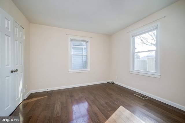 spare room featuring dark hardwood / wood-style flooring