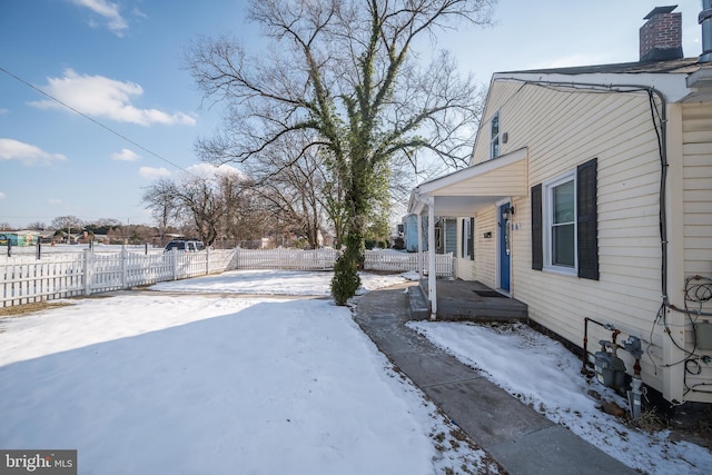 yard layered in snow featuring covered porch