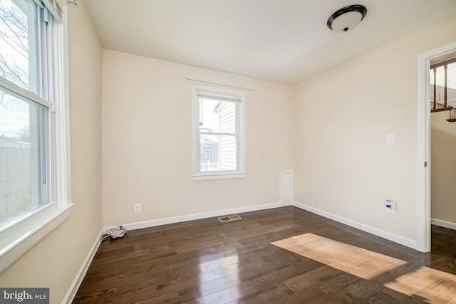 spare room with dark hardwood / wood-style floors