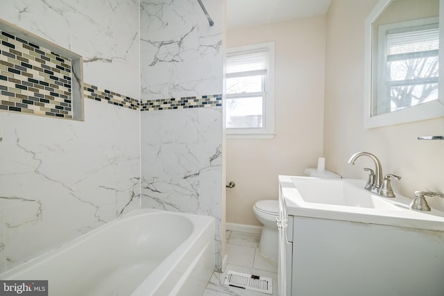 full bathroom featuring vanity, a healthy amount of sunlight, tiled shower / bath, and toilet