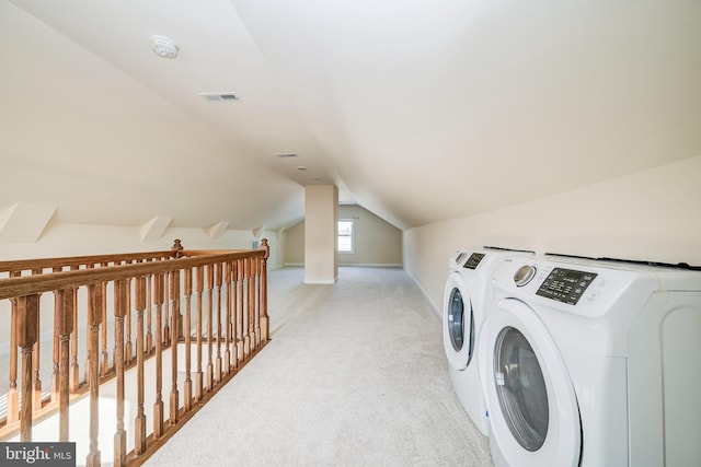 washroom featuring washer and clothes dryer and light colored carpet