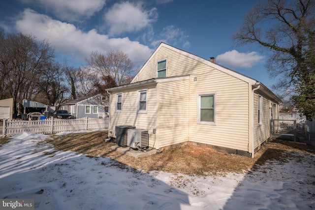 snow covered property featuring cooling unit