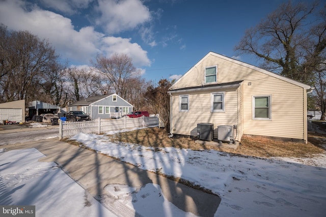 snow covered property featuring central AC