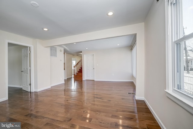 empty room with dark hardwood / wood-style flooring