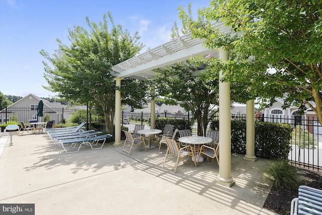 view of patio featuring radiator heating unit and a pergola