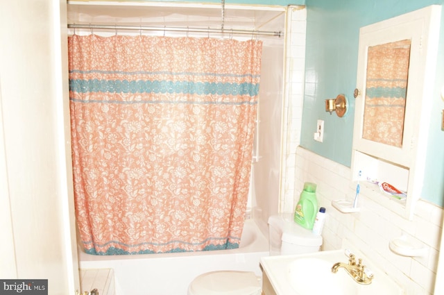 full bathroom with vanity, toilet, tile walls, and shower / bath combo