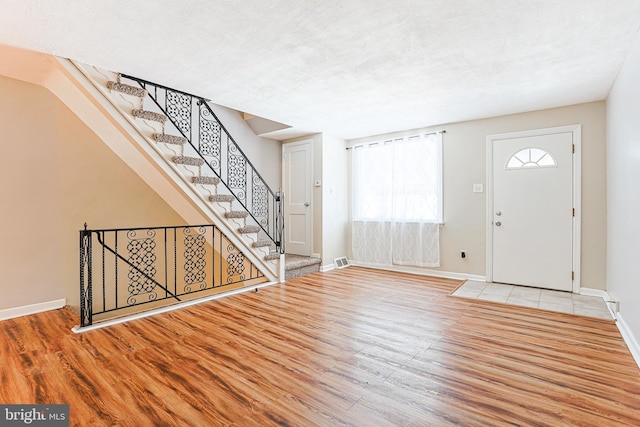 entrance foyer featuring light hardwood / wood-style flooring and a textured ceiling