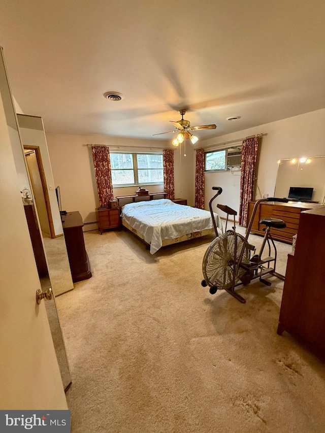 bedroom featuring visible vents, carpet floors, baseboard heating, and ceiling fan