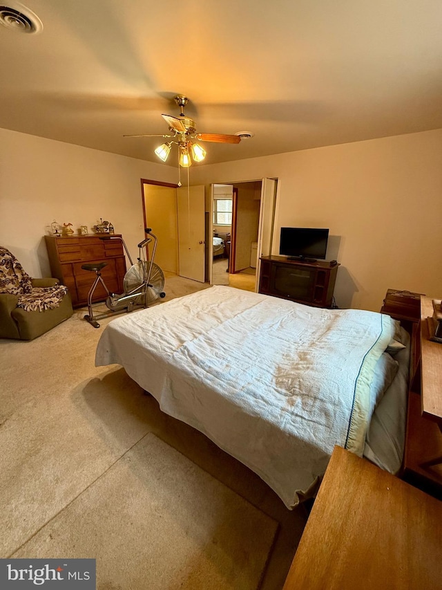 bedroom featuring carpet flooring, a ceiling fan, and visible vents