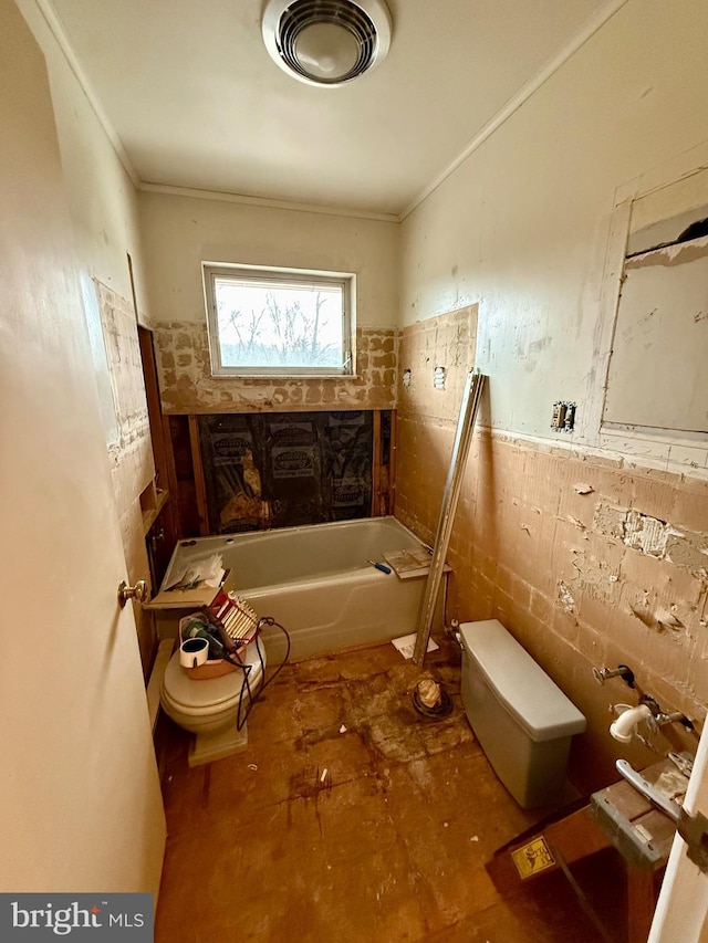 full bath with tile walls, toilet, a tub to relax in, and crown molding