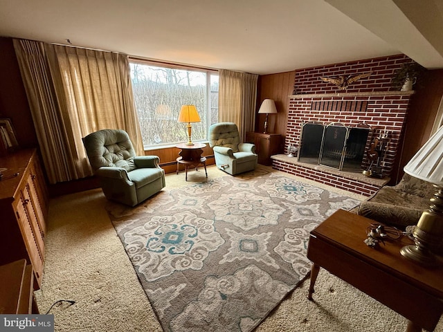 living area with a brick fireplace and carpet floors