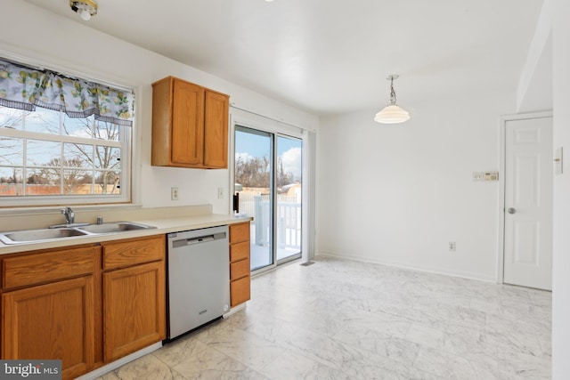 kitchen featuring hanging light fixtures, sink, and stainless steel dishwasher