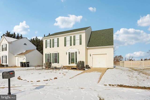 colonial inspired home featuring a garage