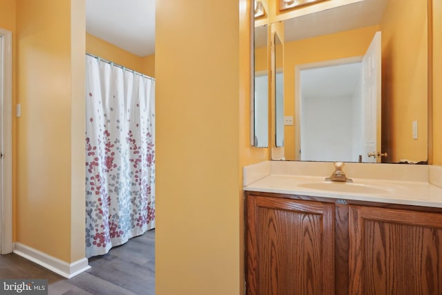 bathroom featuring wood-type flooring and vanity