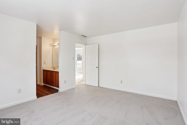 carpeted spare room with sink