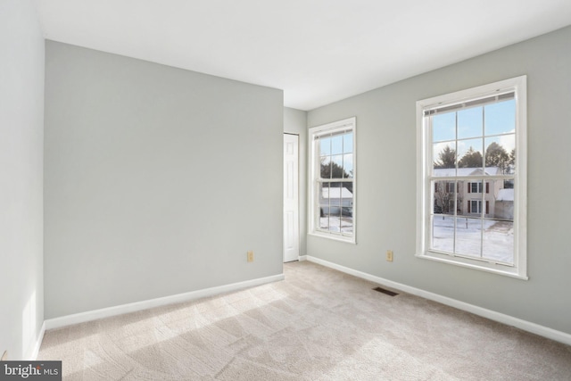 empty room with light colored carpet