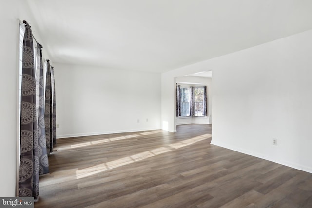 unfurnished room featuring dark hardwood / wood-style flooring