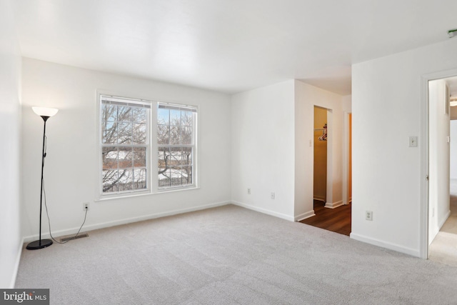 spare room with dark colored carpet