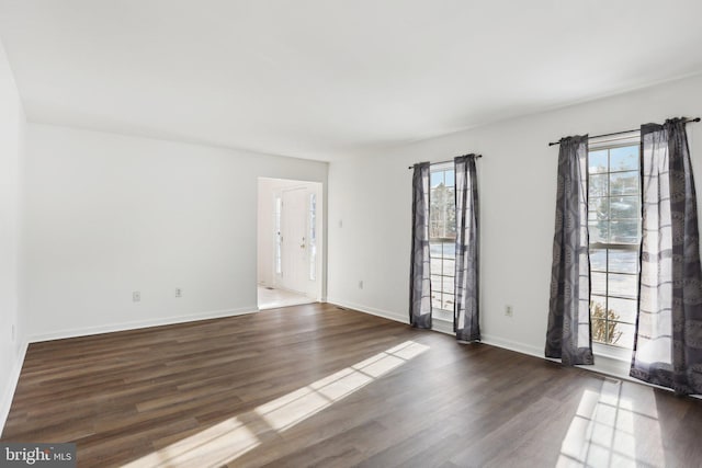 empty room featuring dark hardwood / wood-style flooring