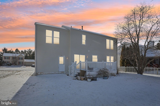 view of back house at dusk