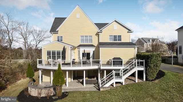 back of property with a patio area, a lawn, a deck, and stairs