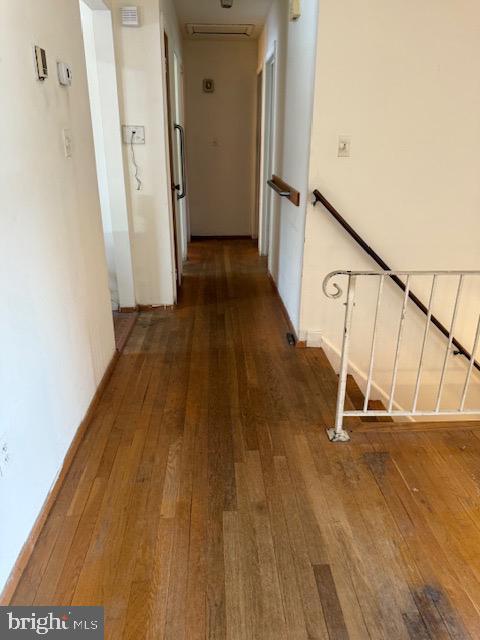 hall featuring dark wood-type flooring and radiator heating unit