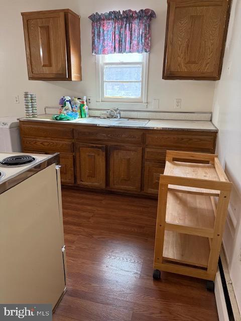 kitchen with electric stove, dark hardwood / wood-style floors, and sink