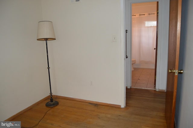 corridor with light hardwood / wood-style flooring