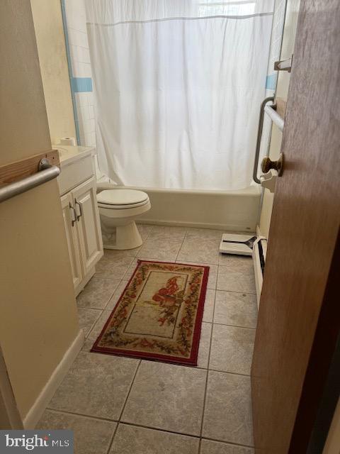 full bathroom featuring shower / tub combo, vanity, toilet, and tile patterned flooring