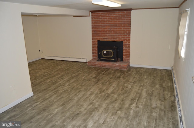 unfurnished living room featuring baseboard heating, ornamental molding, and dark hardwood / wood-style floors